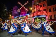 Open air French Can Can performance at the Moulin Rouge to celebrate the return of its windmill blades