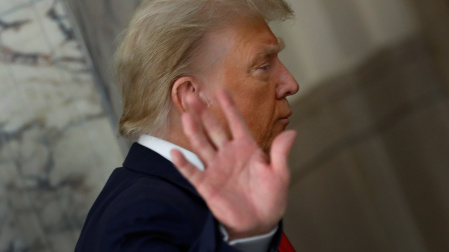 Former US President Donald J. Trump gestures to the media during a short recess on the third day of his civil fraud trial in New York.