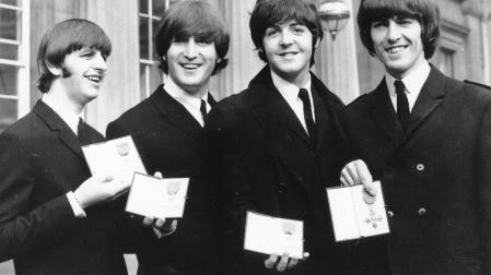 FILE - In this Oct. 26, 1965 file photo The Beatles, from left: Ringo Starr, John Lennon, Paul McCartney and George Harrison smile as they display the Member of The Order of The British Empire medals presented to them by Queen Elizabeth II in a ceremony in Buckingham Palace in London, England. The Beatles' psychedelic masterwork "Sgt. Pepper's Lonely Hearts Club Band" has been named the most popular British album in history. (AP Photo, File)