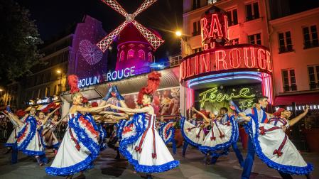 Open air French Can Can performance at the Moulin Rouge to celebrate the return of its windmill blades