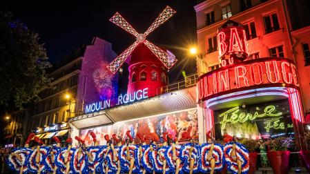 Open air French Can Can performance at the Moulin Rouge to celebrate the return of its windmill blades