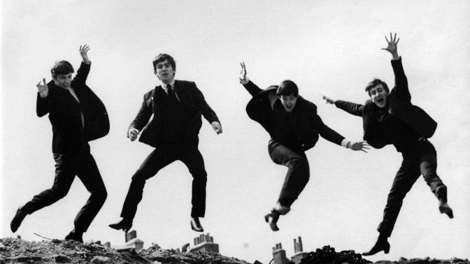 Photo of BEATLES; L-R: Ringo Starr, George Harrison, Paul McCartney, John Lennon - posed, group shot - jumping on wall, Used on the Twist & Shout EP cover 